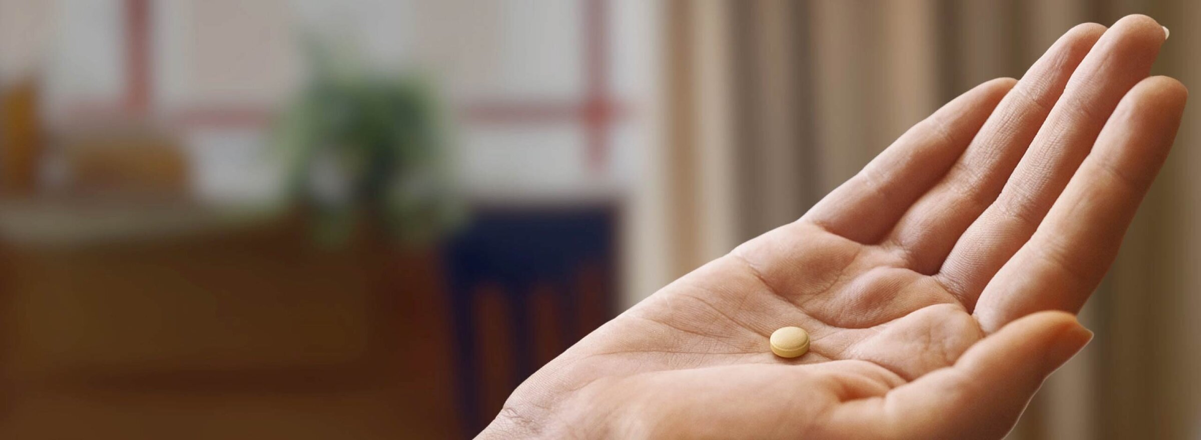 Hand holding RHAPSIDO pill.